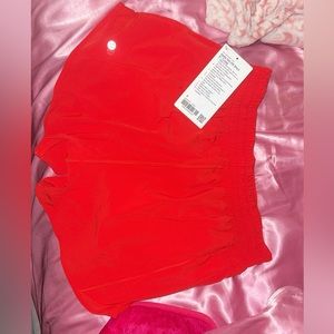 Never worn, tags still attached. Red size 8 lulu shorts ‘4 inseam